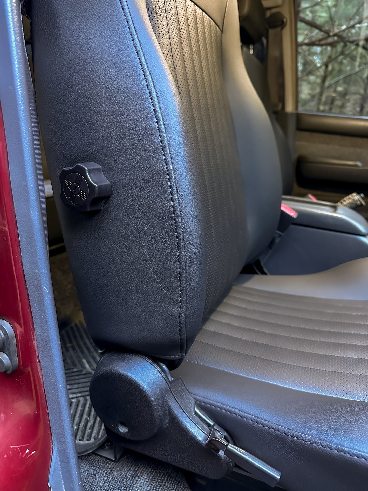 Black front seat with adjustable bolster